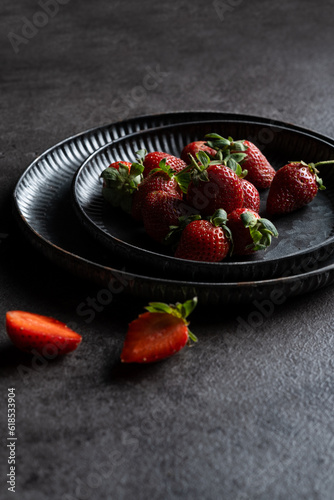 a pile of strawberry on rustic background