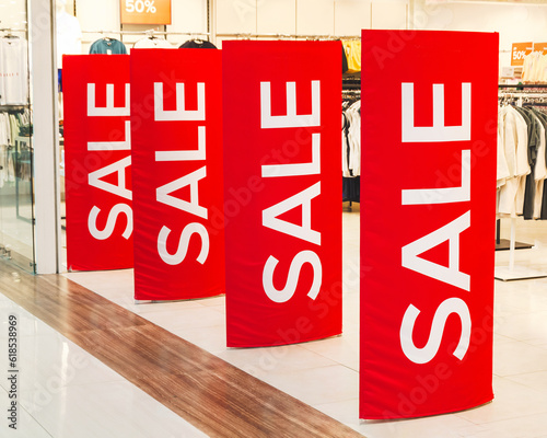 white word Sale on red anti-theft gate sensor at entrance to clothing store. discount, black friday