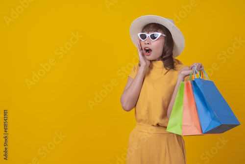 Modern happy asian Female lifestyle fashion portrait. beautiful attractive young woman girl enjoy stylish walk with shopping bag packages on the department store, trendy outfit on shopping mall