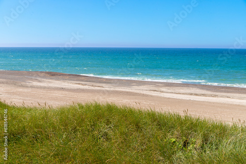 overgrown dunes on the beach in Denmark with sea in the background photo