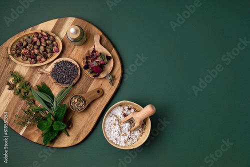 Botanical blends, salt, herbs, essencial oils for naturopathy. Natural remedy, herbal medicine, blends for bath and tea on wooden table background
