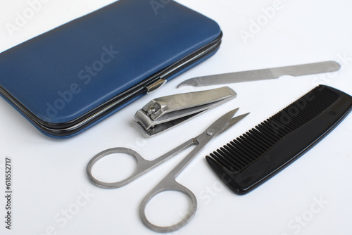 Hairdresser and pedicure tools. Nose hair trimmer, scissors, little nail file and tweezers for man's hand nail care.