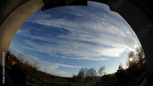 Wallpaper Mural Panorama 180 and time lapse - evening window view with sunny and blue sky, moving clouds, sunset and horizon with snow, trees, car traffic on national road DK1 in Poland Torontodigital.ca