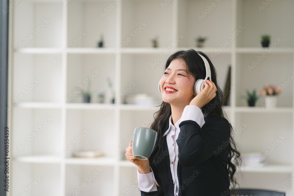 Portrait of a young asian woman enjoy drinking coffee and listening to music with headphone. Portrait of a young asian woman enjoy drinking coffee and listening to music with headphone.