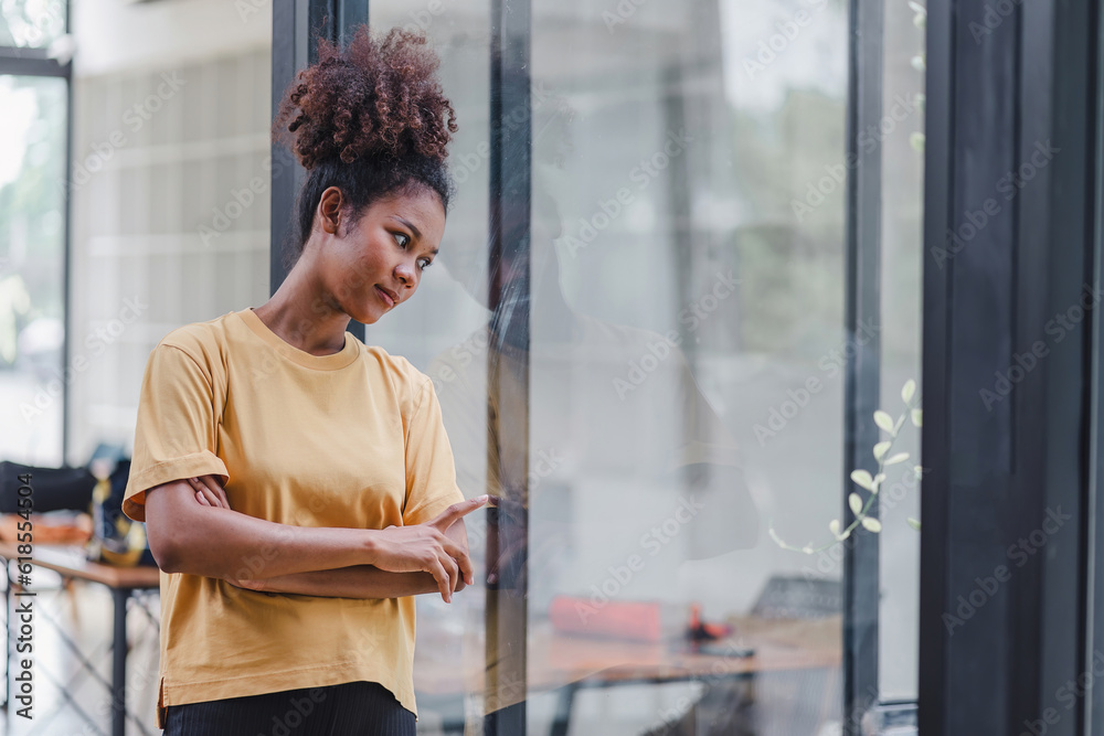 African American woman with afro hair standing, looking away at the window. The frustrated and confused female appears unhappy, dealing with personal life problems. African American woman with afro hair standing, looking away at the window. The frustrated and confused female appears unhappy, dealing with personal life problems.