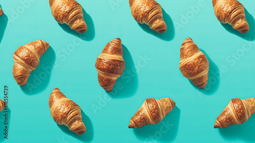 Delicious freshly baked crispy croissants on a turquoise minimal background. Flatlay pattern. Generative AI.