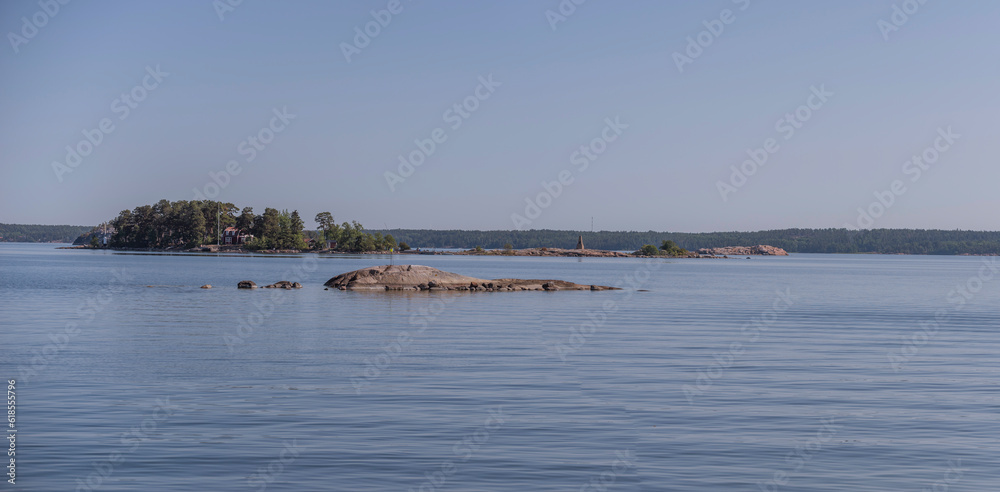 Island and rocky islet in archipelago, a sunny summer morning in Stockholm Island and rocky islet in archipelago, a sunny summer morning in Stockholm