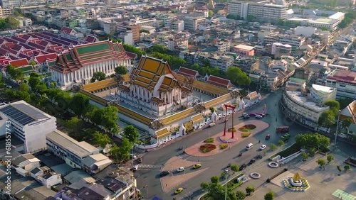 Aerial top view of Giant Swing or Sao Ching Cha monument with Wat Suthat temple at sunset in old town, Bangkok City, Thailand. Landmark tourist attraction. Thai architecture with travel trip concept.