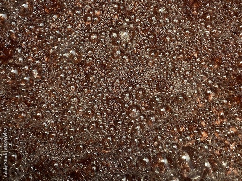 Bubbles formed on the surface of wine must caused by the residual carbon dioxide produced during the fermentation activity of yeast. Textures, close up