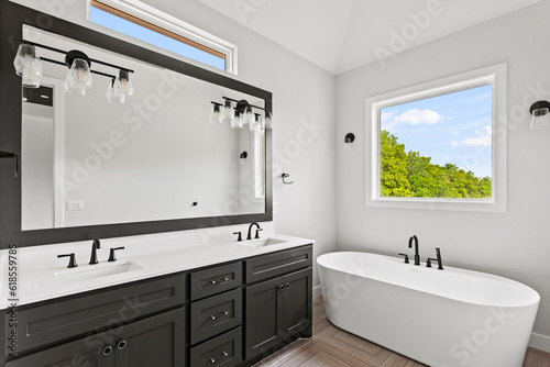 Brand new build  contemporary bathroom with subway tiles  drop in tub and brand new marble flooring and marble counter tops. 