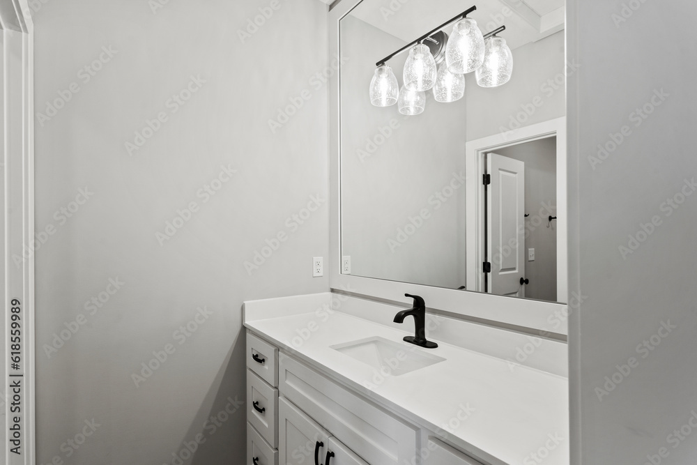 bathroom interior with toliet, black light fixtures and white counter tops bathroom interior with toliet, black light fixtures and white counter tops