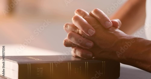 Sunlight Falling On Woman's Hand Over Holy Bible