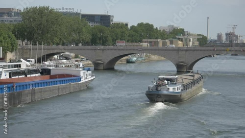View of a bridge in Paris with a barge on the river