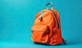 Orange school backpack on blue background, back to school concept with copy space, generative AI