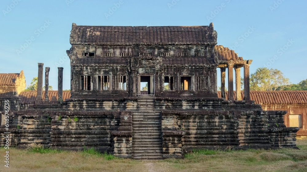 An antiquated Khmer structure lies abandoned amidst the ruins of the medieval city of Angkor, its silent presence evoking an air of mystique.