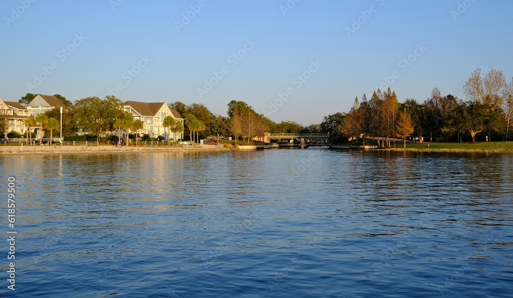 Fototapeta premium Golden hour sunset over lake with buildings being reflected in the background in winter Florida 