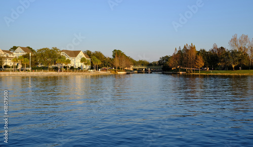 Golden hour sunset over lake with buildings being reflected in the background in winter Florida 
