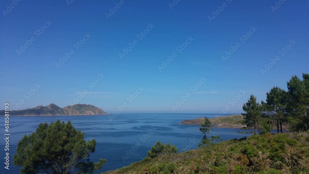 Serene Coastal Scenery with Vibrant Blue Ocean, Lush Green Foliage and Distant Islands Under Clear Blue Sky Serene Coastal Scenery with Vibrant Blue Ocean, Lush Green Foliage and Distant Islands Under Clear Blue Sky