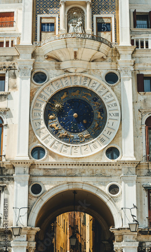 Detail of clock tower with medieval figures and fine architecture elements under sunny sky 