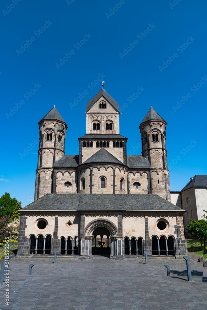 The abbey of maria laach in germany on a sunny day with blue sky