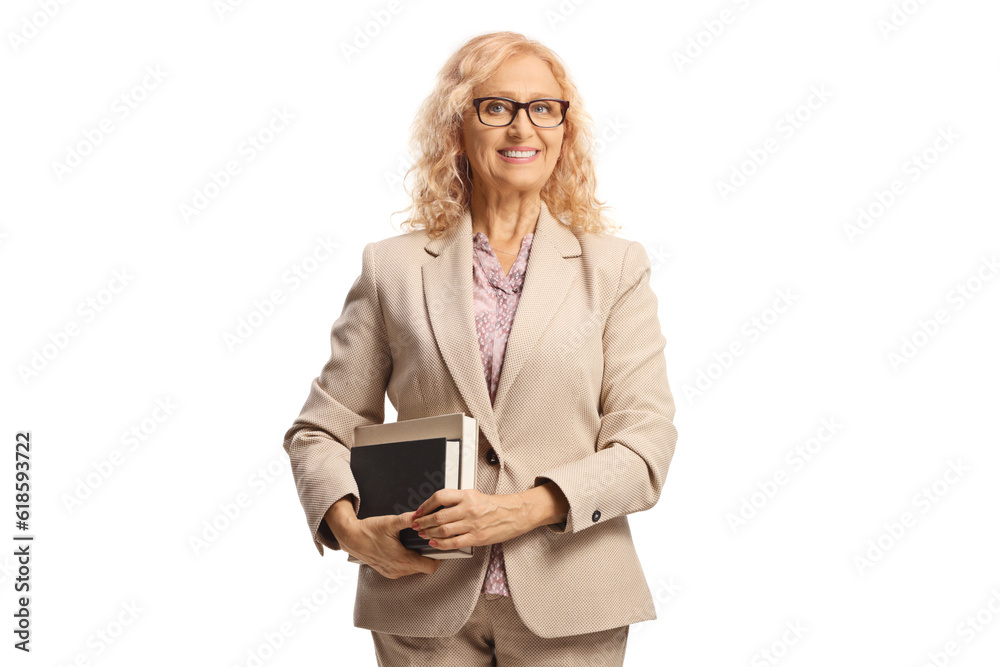 Female teacher holding books and smiling Female teacher holding books and smiling