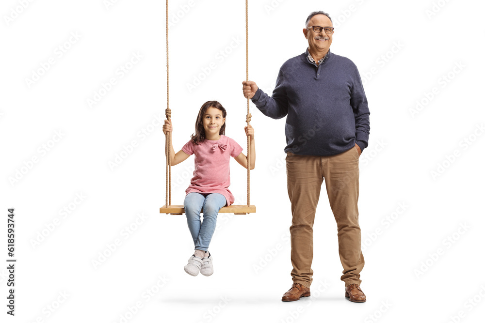 Grandfather standing next to girl on a wooden swing Grandfather standing next to girl on a wooden swing