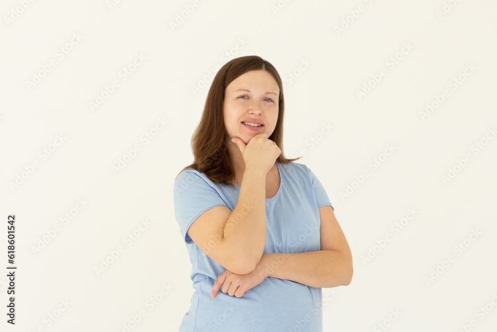Happy successful woman standing in casual outfit, smiling pleased at camera and looking confident, standing against white background Happy successful woman standing in casual outfit, smiling pleased at camera and looking confident, standing against white background