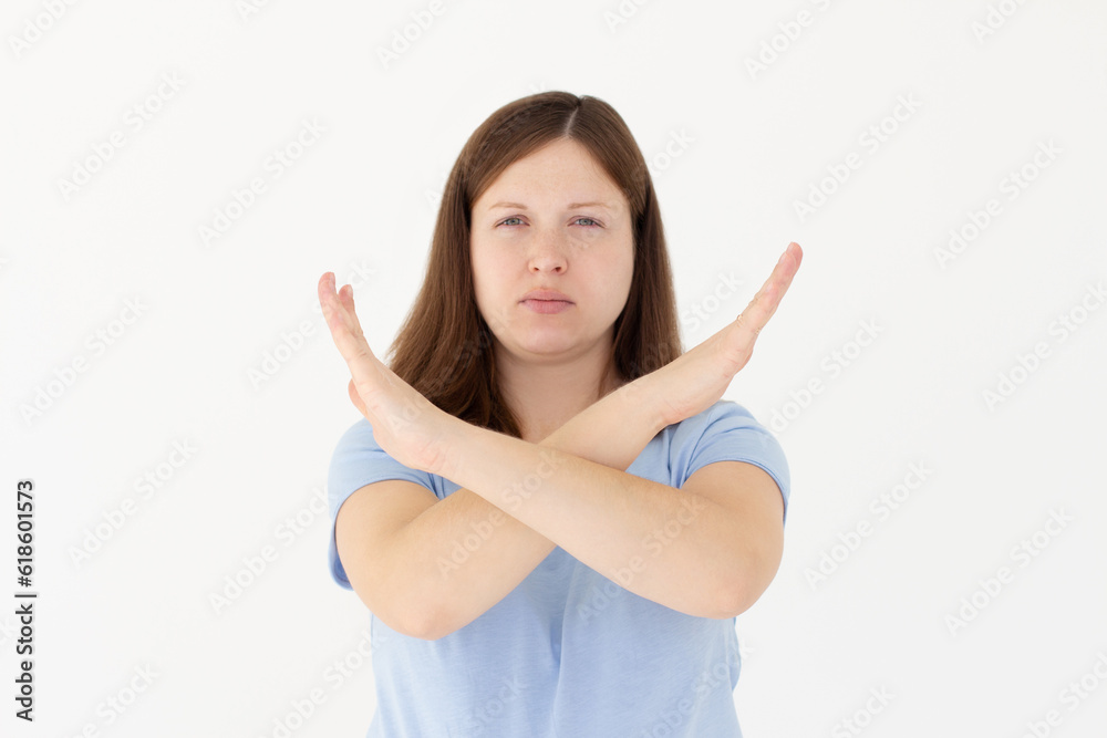 Portrait of serious, unhappy, confident brunette woman holding two arms crossed, gesturing no sign, looking at camera, isolated on white background Portrait of serious, unhappy, confident brunette woman holding two arms crossed, gesturing no sign, looking at camera, isolated on white background