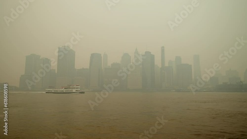 Boat Crossing Smoggy New York City Skyline