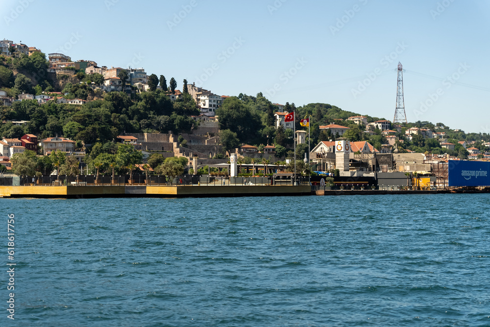 Touristic sightseeing ships in Golden Horn bay of Istanbul and mosque with Sultanahmet district against blue sky and clouds. Istanbul, Turkey during sunny summer day