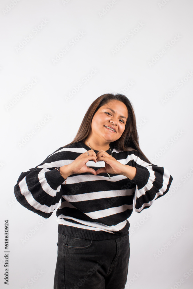 photograph of latin woman making a heart with her hands. Concept of people and emotions. photograph of latin woman making a heart with her hands. Concept of people and emotions.