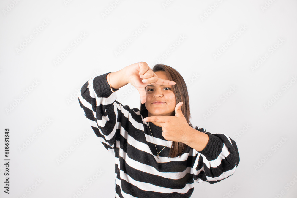 Portrait of Latin woman making a symbol with her hands. Concept of people and portraits. Portrait of Latin woman making a symbol with her hands. Concept of people and portraits.