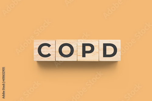 COPD (Chronic Obstructive Pulmonary Disease) wooden cubes on orange background