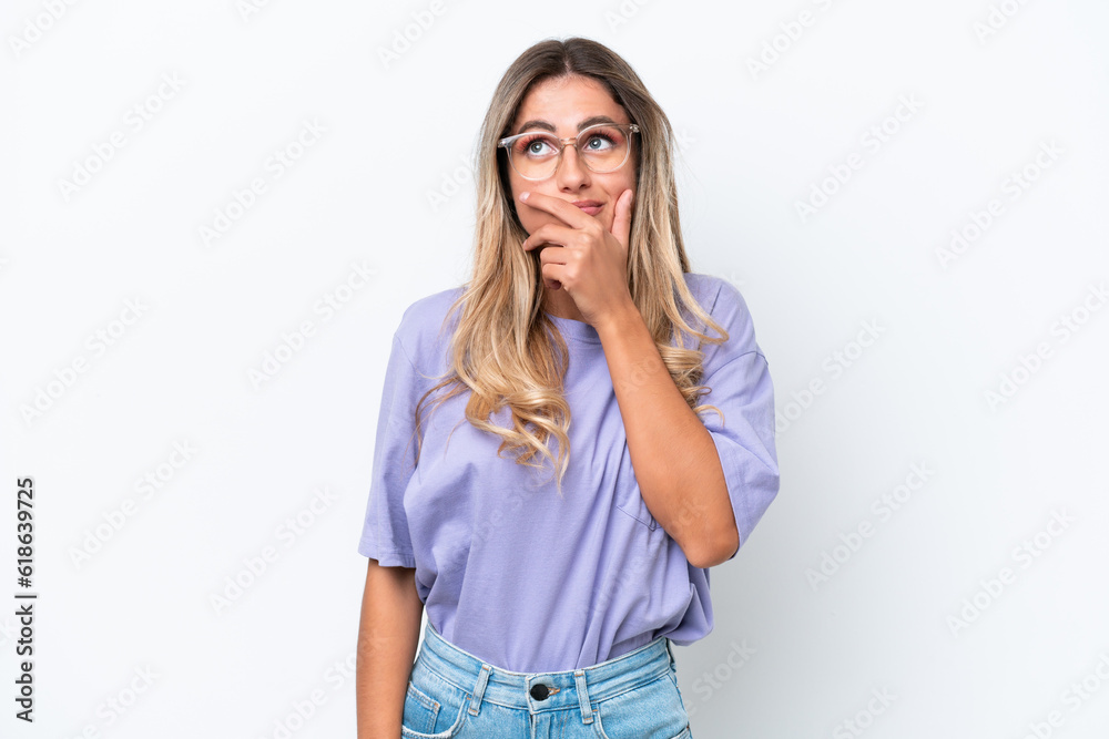 Young Uruguayan woman isolated on white background having doubts and with confuse face expression