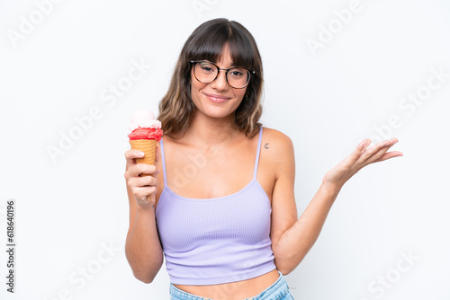 Young caucasian woman with a cornet ice cream over isolated white background with shocked facial expression