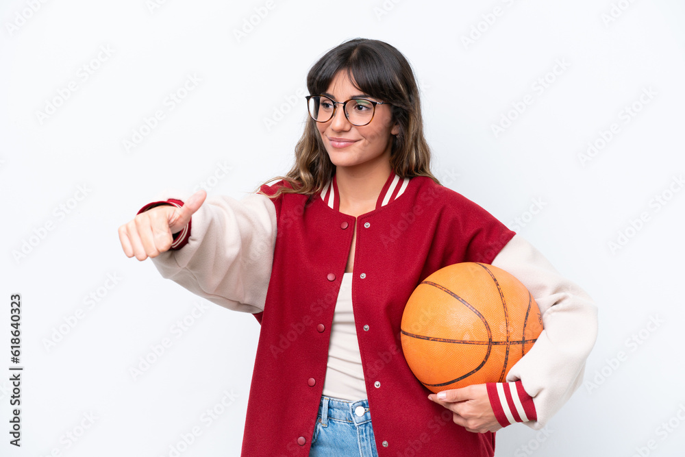 Young caucasian woman playing basketball isolated on white background giving a thumbs up gesture Young caucasian woman playing basketball isolated on white background giving a thumbs up gesture