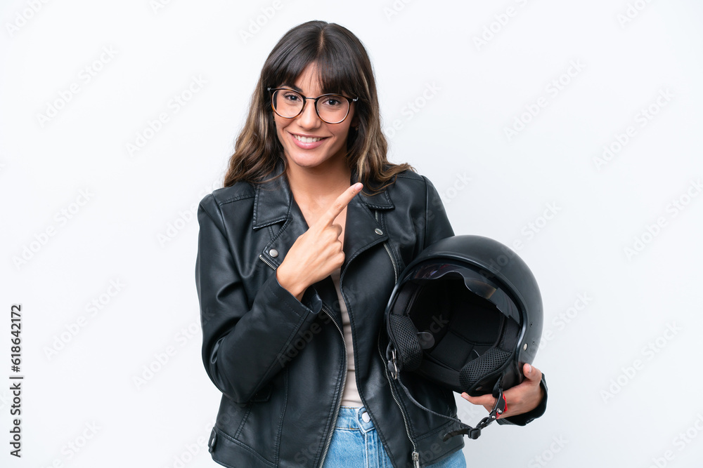 Young caucasian woman with a motorcycle helmet isolated on white background pointing to the side to present a product Young caucasian woman with a motorcycle helmet isolated on white background pointing to the side to present a product