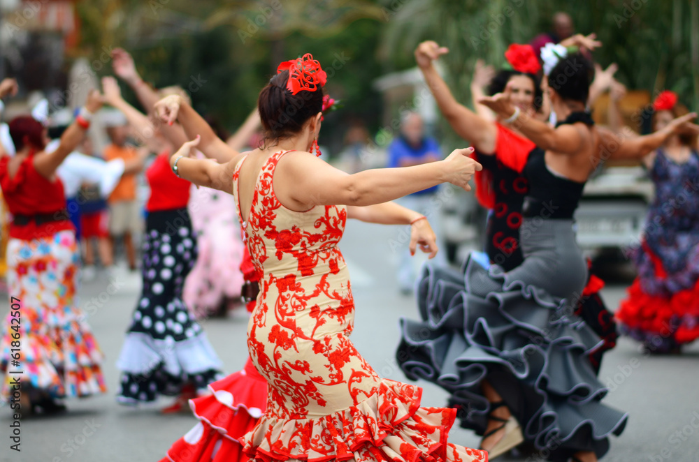Fototapeta premium Women dancing back to back wearing flamenco style clothing at the Spanish Romeria festival