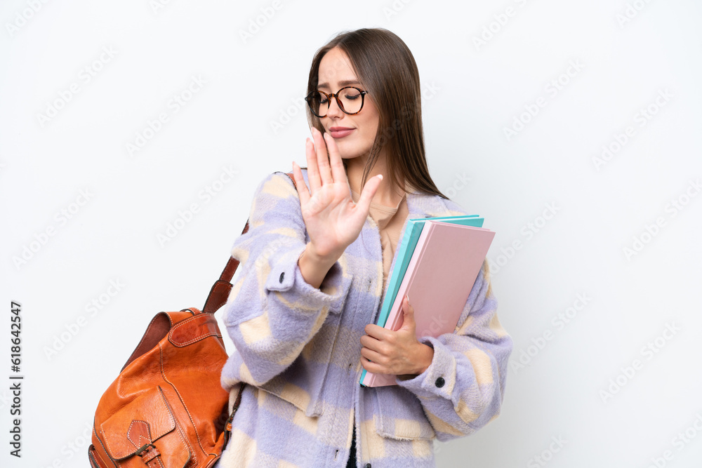 Young beautiful student woman isolated on white background making stop gesture and disappointed Young beautiful student woman isolated on white background making stop gesture and disappointed