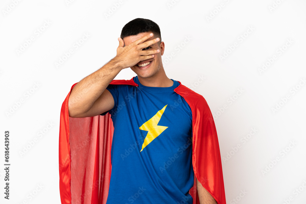 Super Hero over isolated white background covering eyes by hands and smiling Super Hero over isolated white background covering eyes by hands and smiling