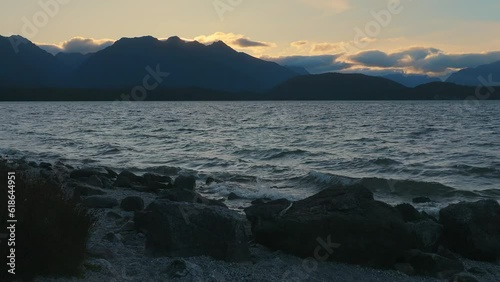 Aerial: wind over Lake at sunset, Manapouri, New Zealand photo