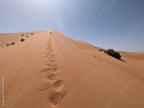 Hiking up the Great Dune of Merzouga in the Erg Chebbi desert  Moroccan Sahara
