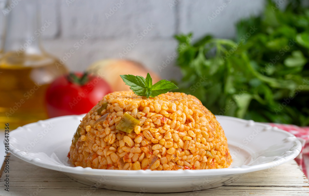 Traditional turkish bulgur pilaf with tomato sause in plate (Turkish name; meyhane pilavi) Traditional turkish bulgur pilaf with tomato sause in plate (Turkish name; meyhane pilavi)