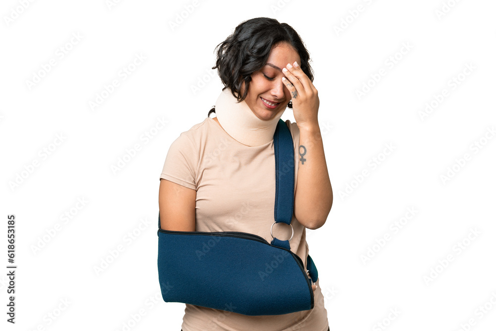 Young argentinian woman wearing neck brace and sling over isolated background laughing Young argentinian woman wearing neck brace and sling over isolated background laughing