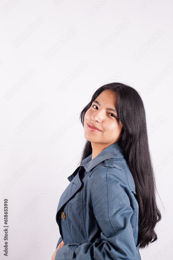 Portrait of young attractive hispan woman on a light background of photographic studio. Concept of people.