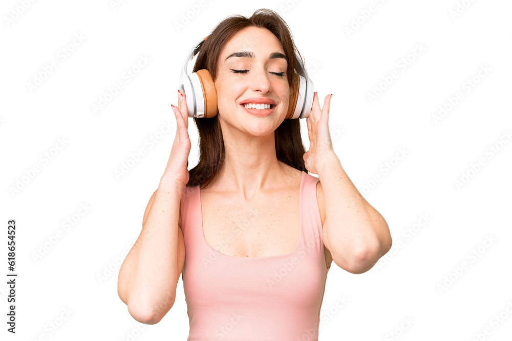 Young caucasian woman over isolated chroma key background listening music and singing Young caucasian woman over isolated chroma key background listening music and singing