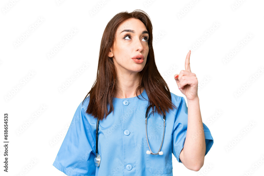 Young nurse woman over isolated chroma key background pointing up and surprised Young nurse woman over isolated chroma key background pointing up and surprised