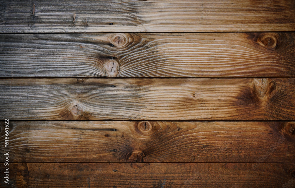 Dark stained reclaimed wood surface with aged boards lined up. Wooden floor planks with grain and texture. Dark stained reclaimed wood surface with aged boards lined up. Wooden floor planks with grain and texture.