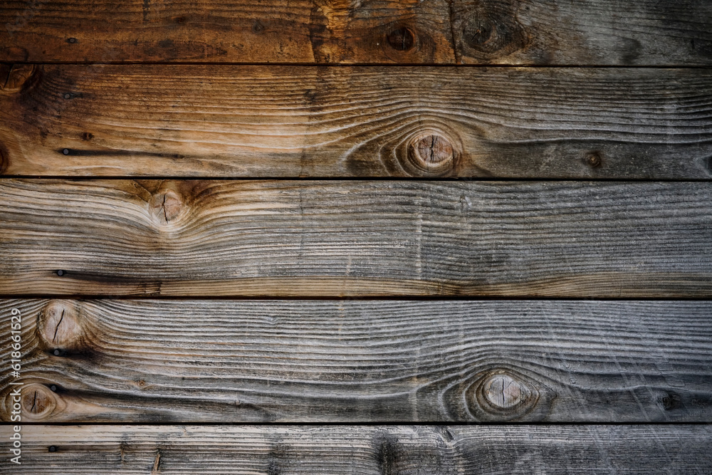 Dark stained reclaimed wood surface with aged boards lined up. Wooden floor planks with grain and texture. Dark stained reclaimed wood surface with aged boards lined up. Wooden floor planks with grain and texture.