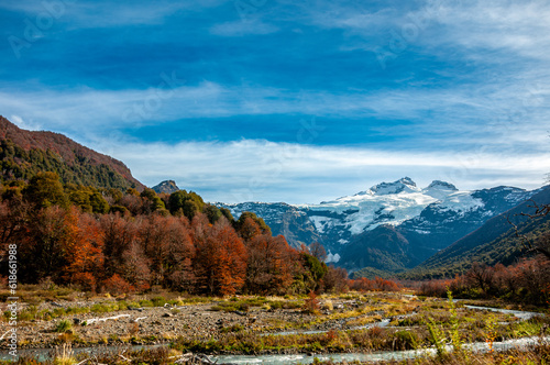 view of snow-covered Cerro Tronador and patagonian andean forest in autumn